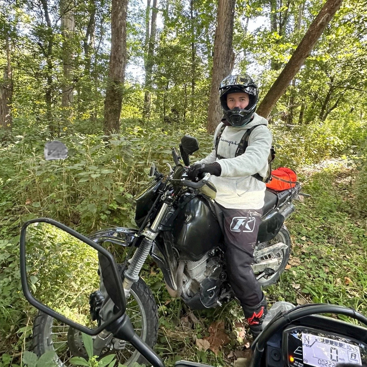 Flexi Fender rider on a Suzuki DR650 on a wooded trail